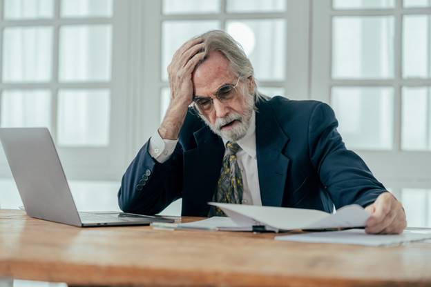 Older man stressed at work - Age Discrimination